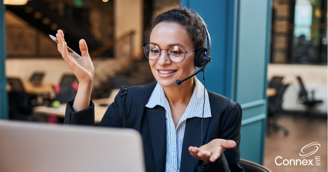 A woman practicing virtual meeting etiquette while on the phone