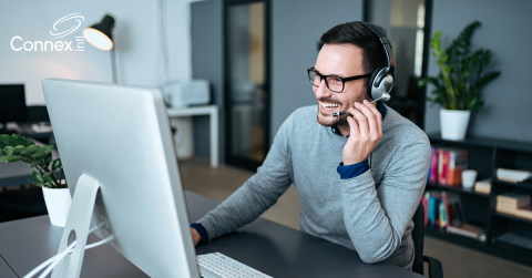 A man with a headset talking on a virtual meeting